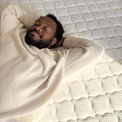 Man relaxing on ABLYEA Gray Luxe Hybrid Mattress for comfortable everyday sleep